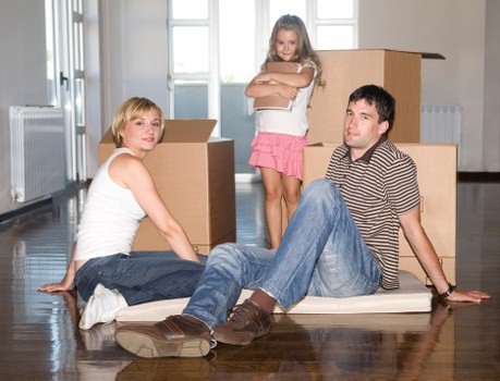 Professional movers handling stair access during a flat removal